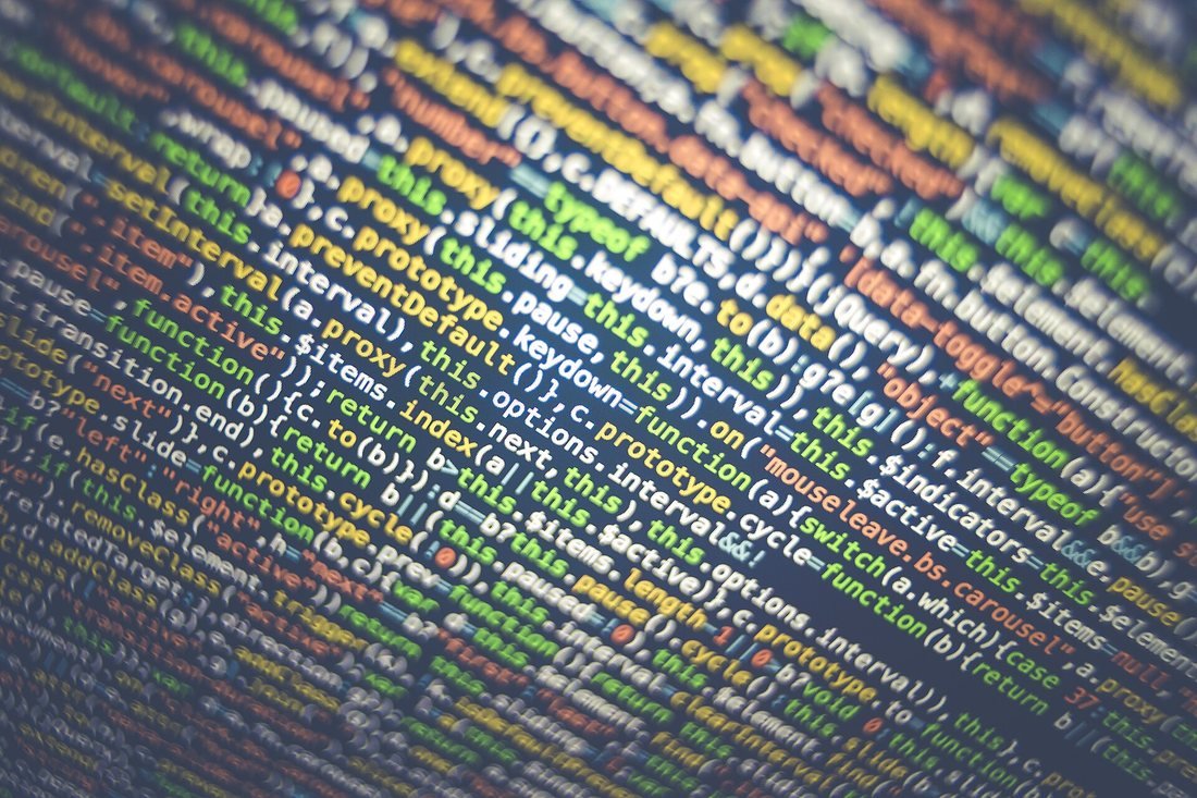 Colorful lines of source code glowing on a dark screen